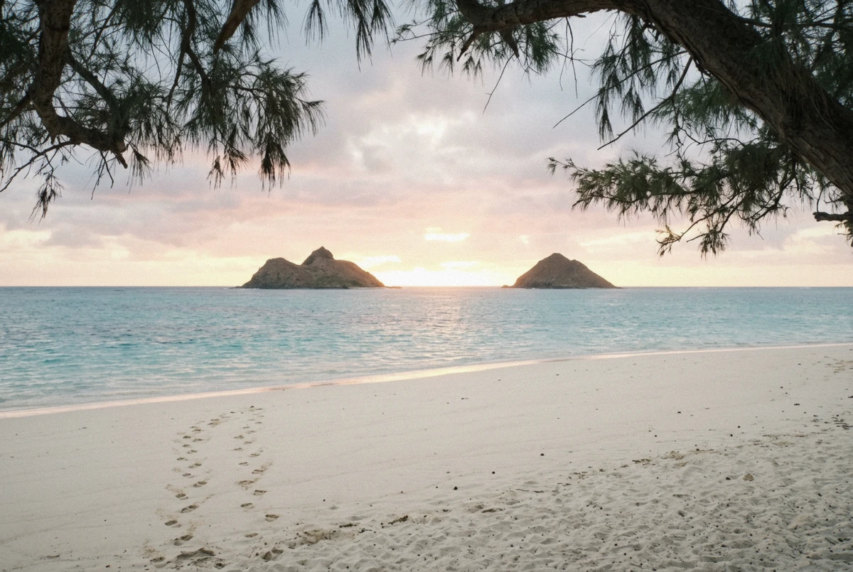 Sunrise over the Mokulua islands from Lanikai Beach, a windward backdrop for an Oahu photoshoot in Hawaii